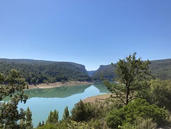 Scenic view of mountains against clear blue sky