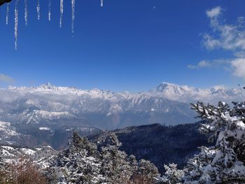 Scenic view of snowcapped mountains against sky