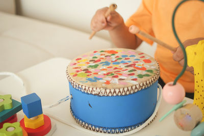 Cropped hand of woman holding cake