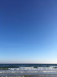 Scenic view of sea against clear blue sky