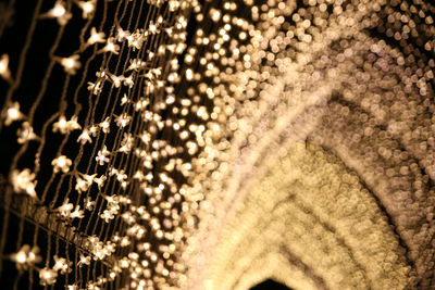Low angle view of illuminated decoration hanging at night
