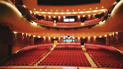 View of red chairs in auditorium