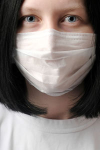 Girl in medical disposable mask looking at the camera.the concept of the epidemic coronavirus