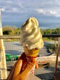 Hand holding ice cream cone