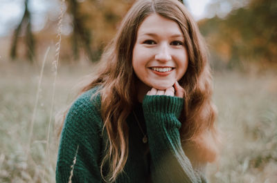 Portrait of smiling girl sitting on field