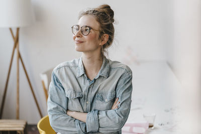 Smiling young woman in office looking sideways