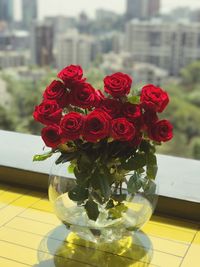 Close-up of red rose on table