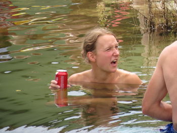 Boy swimming in lake