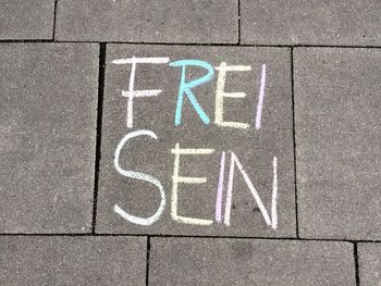 High angle view of text on footpath