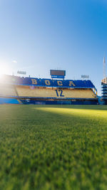 View of soccer field against clear blue sky