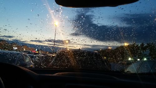 City seen through wet glass window during rainy season