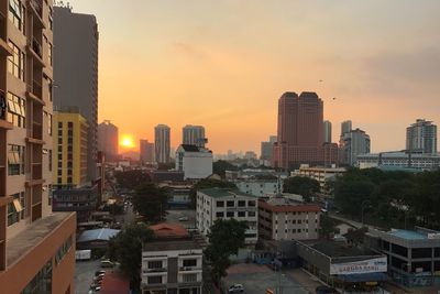 Cityscape against sky during sunset