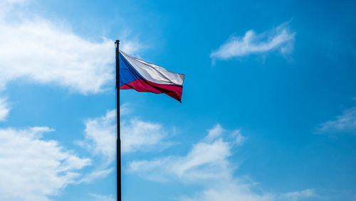 Low angle view of czech flag against blue sky
