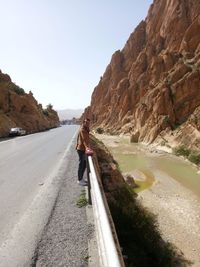 Rear view of man walking on road