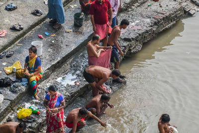 High angle view of people standing by river