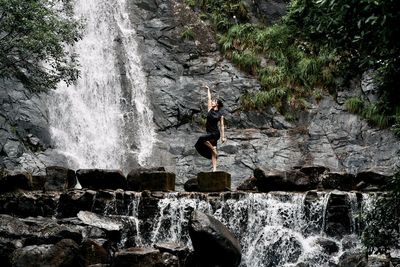 Rear view of man standing on rock