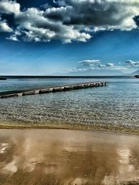 Scenic view of sea against cloudy sky