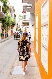 Side view of woman standing on street