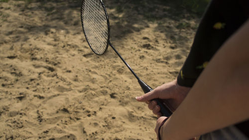 High angle view of person hand on sand