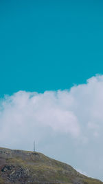 Low angle view of mountain against blue sky