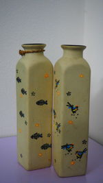 Close-up of bottles on shelf against wall