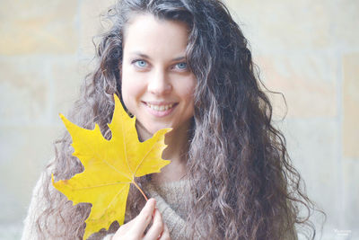 Portrait of young woman with yellow hair in background