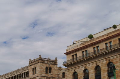 Low angle view of building against cloudy sky
