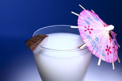 Close-up of drink against blue background