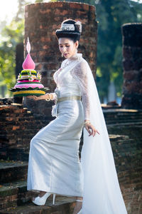 Portrait of young woman standing in temple