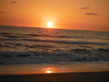 Scenic view of sea against orange sky