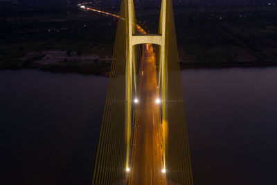 Illuminated bridge against sky at night