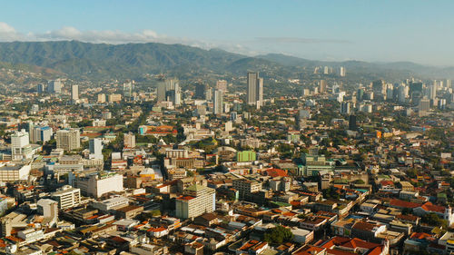 Aerial view of panorama of the city of cebu with skyscrapers and buildings during sunrise. 