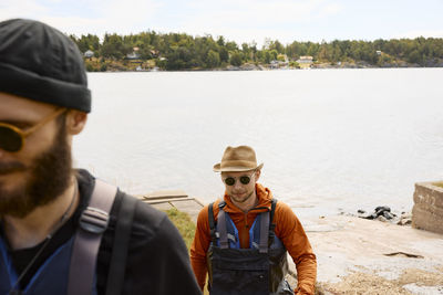 Man wearing life jacket walking at coast