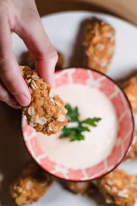 High angle view of hand holding bread in plate
