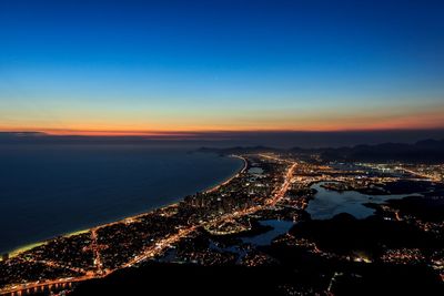 Aerial view of city lit up at night