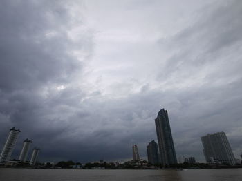 City skyline against cloudy sky