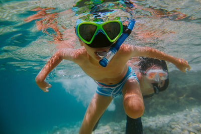 Shirtless boy snorkeling in sea