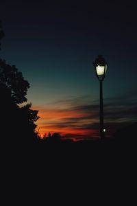 Silhouette street light against sky at night