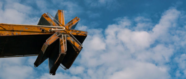 Low angle view of traditional windmill against sky