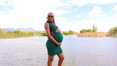 Pregnant black african woman holding her belly