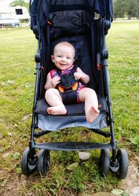 Portrait of cute boy sitting in park