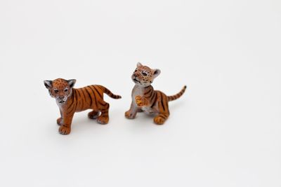 Portrait of tiger toy against white background