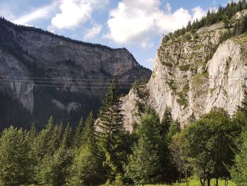 Panoramic view of trees and mountains against sky