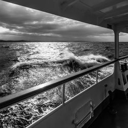 Boat sailing on sea against sky