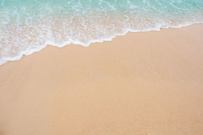 High angle view of waves rushing towards shore