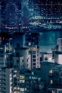 High angle view of illuminated buildings in city at night