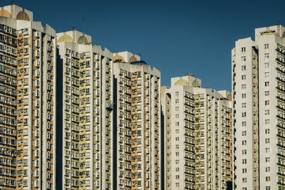 Low angle view of buildings against sky in city