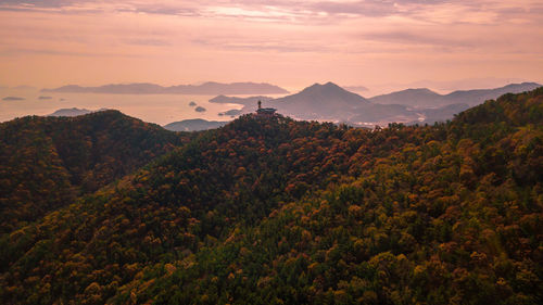 Scenic view of mountains against sky at sunset