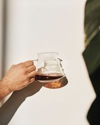 Close-up of hand holding drink glass