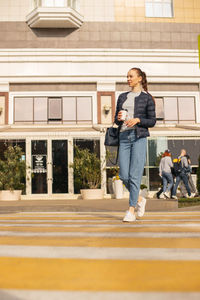 Full length of woman standing on road